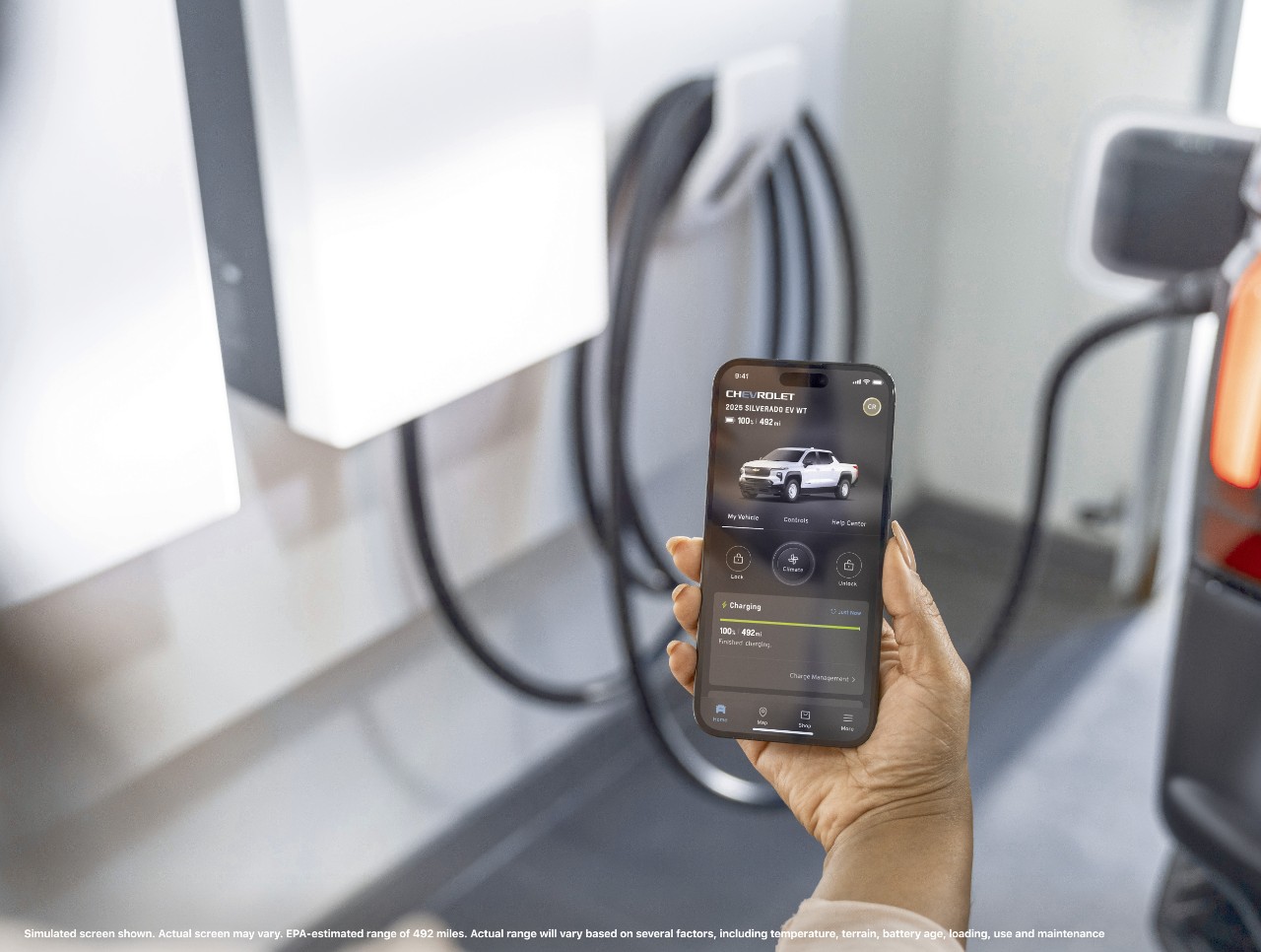 2025 Chevrolet Silverado EV Range A smartphone showing the 2025 Silverado EV WT’s range of 492 miles on the myChevy app.