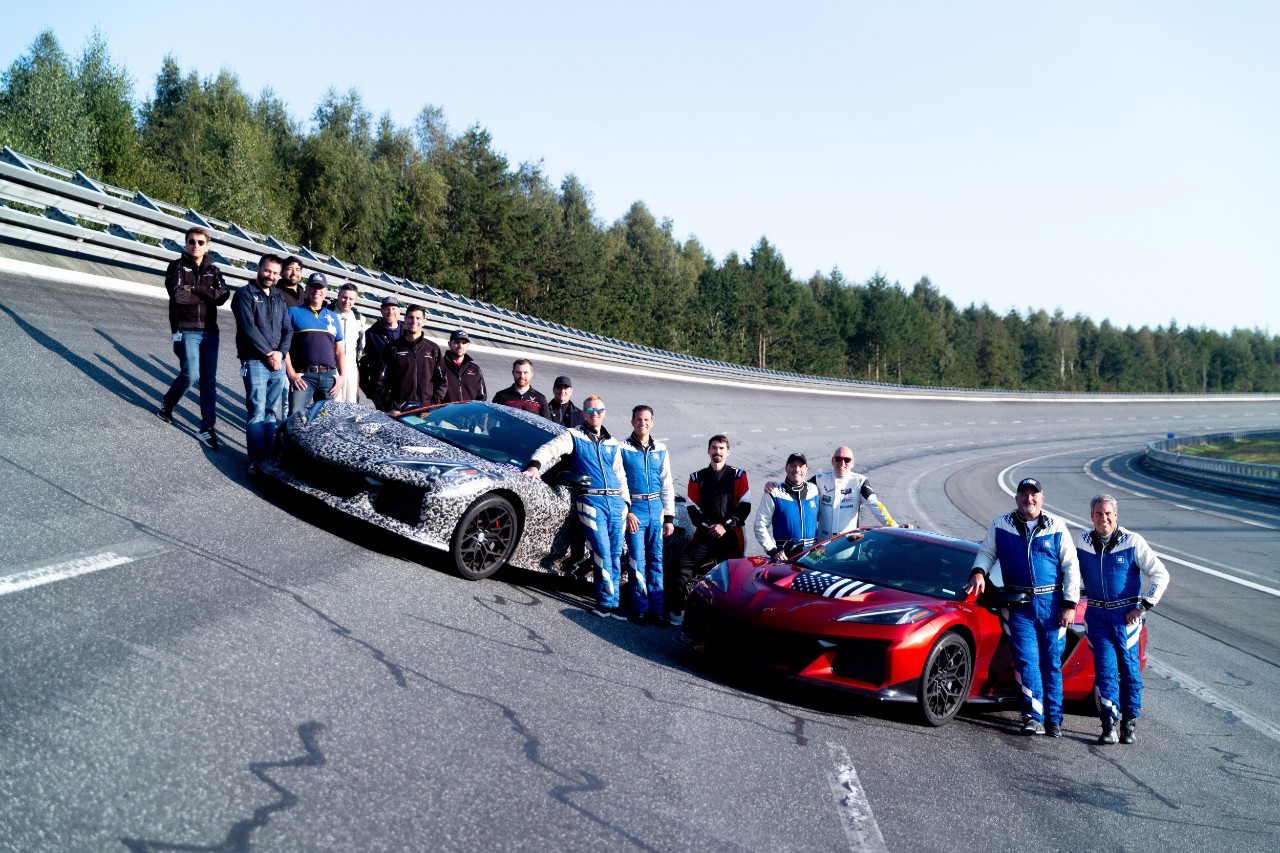 Corvette engineers on racetrack with two Corvettes