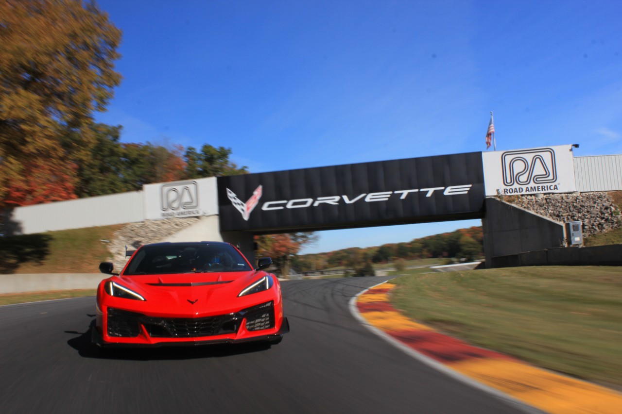 Front-facing view of the 2025 Corvette ZR1 in Torch Red on track at Road America.
