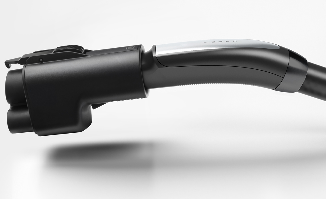 The NACS DC Adapter connected to a Tesla Supercharger cord on a white background